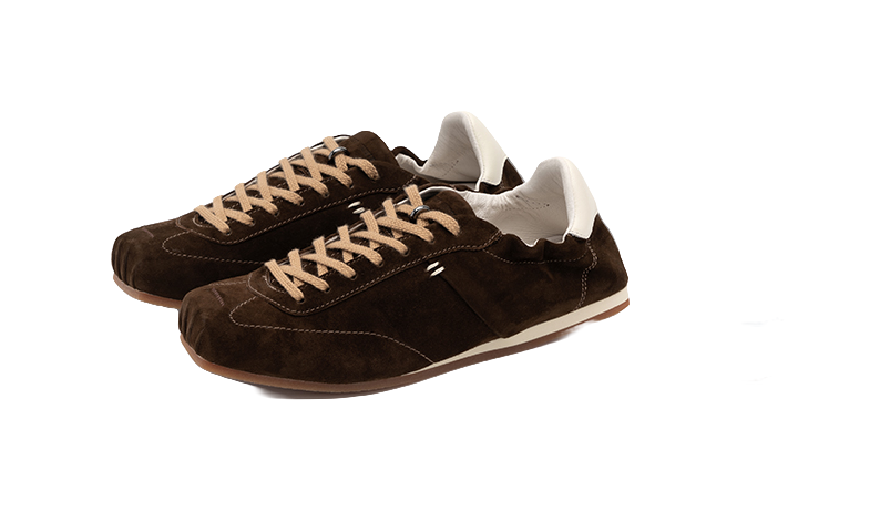 Women's dark brown suede low-top shoes in angled view with lace-up front and white heel tab