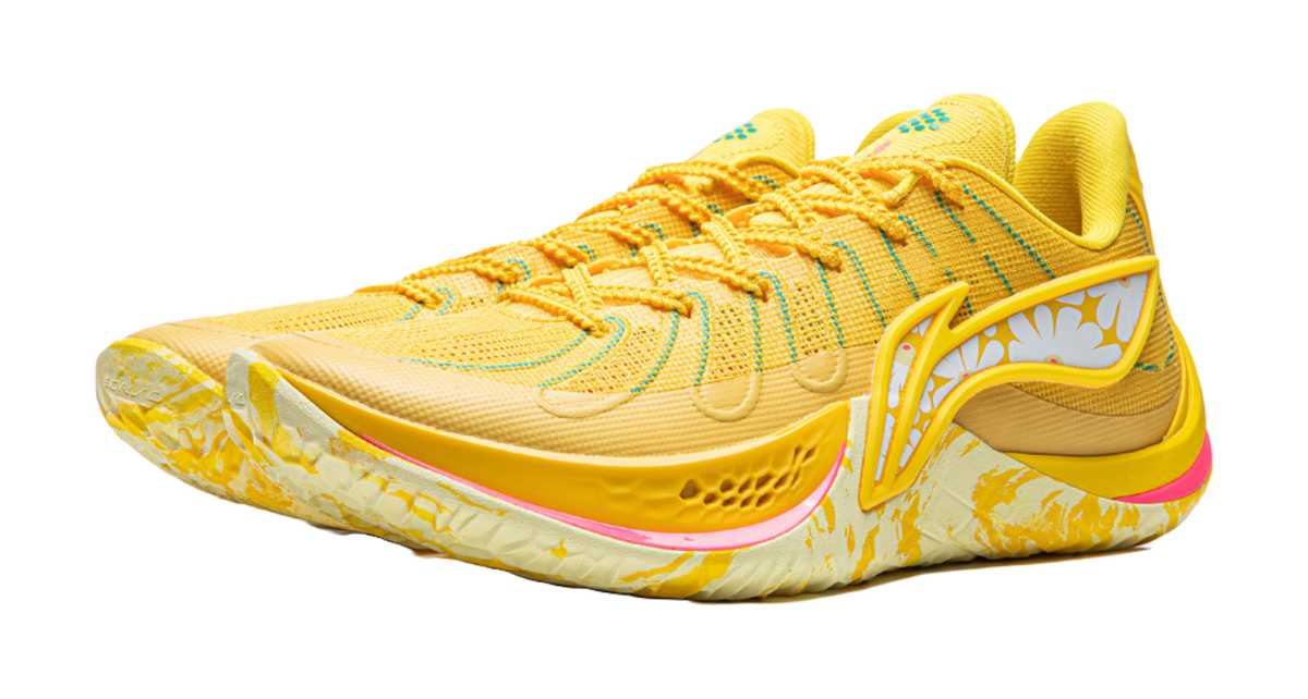 Lemon yellow lace-up basketball shoe with patterned midsole and pink trim along outsole