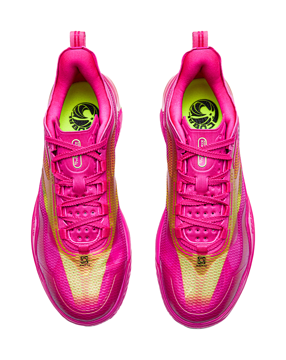 Pair of pink basketball shoes with lace-up vamps and green logo lining