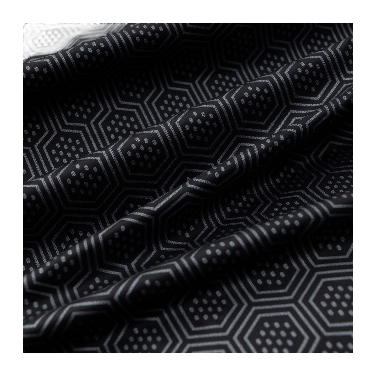 Geometric hex-pattern lining fabric in dark and gray on puffer jacket