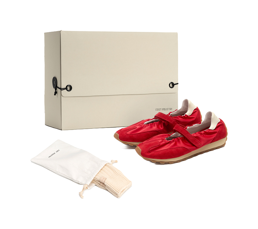 Women's red Mary Jane shoes in packaging, with tan rubber sole and strap