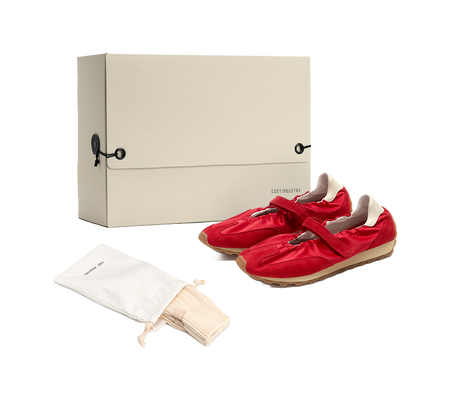 Women's red Mary Jane shoes in packaging, with tan rubber sole and strap