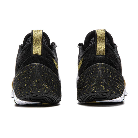 Black basketball shoe pair with gold heel straps and speckled sole pattern