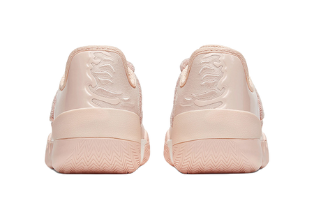 Soft pink low basketball shoes, rear view with molded heel panel and zigzag outsole