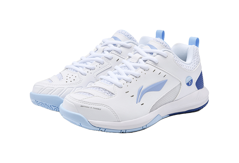 Pair of white badminton shoes with blue detailing, laces, and textured side panels