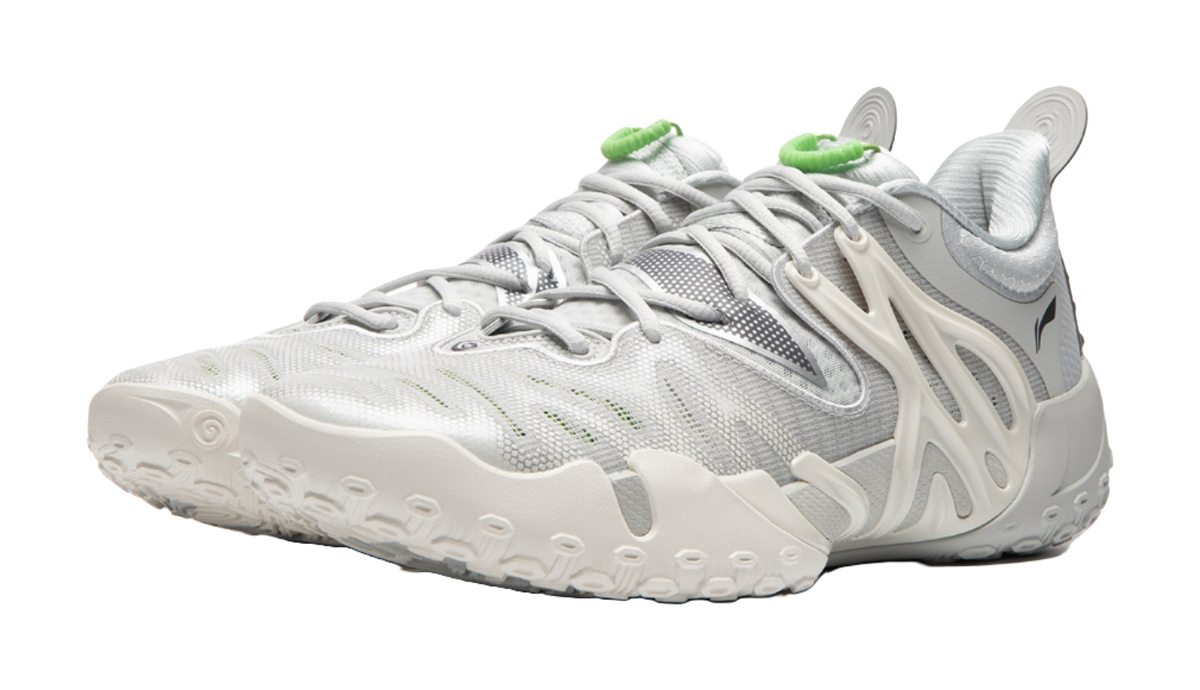 Unisex basketball shoe side view, white knit upper with light gray panels and green trim