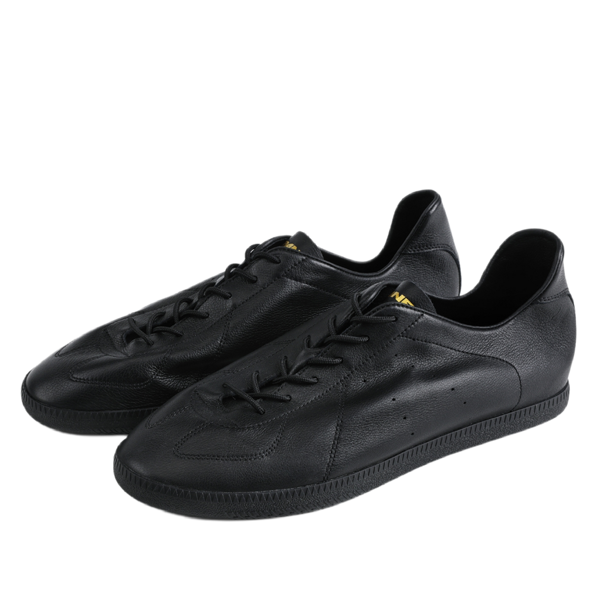 Black low-top training sneakers with lace-up front, sculpted toe, and rubber sole.