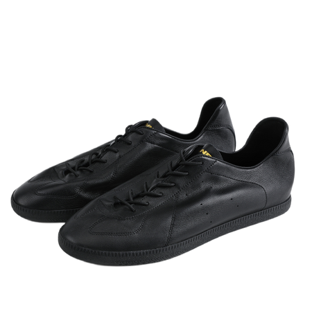 Black low-top training sneakers with lace-up front, sculpted toe, and rubber sole.