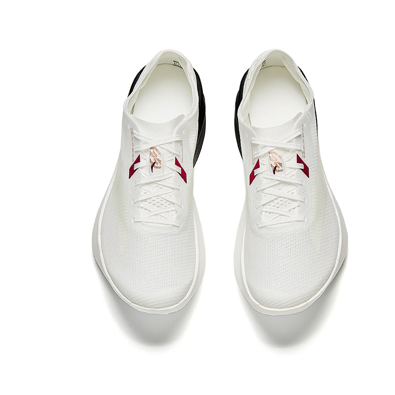 Marathon racing shoe pair with white knit upper and lace-up red logo