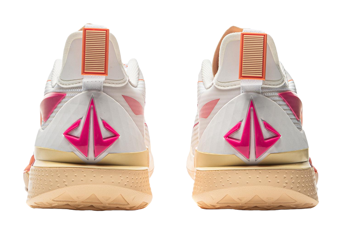 White basketball shoe heels with large magenta logo and orange ribbed tabs