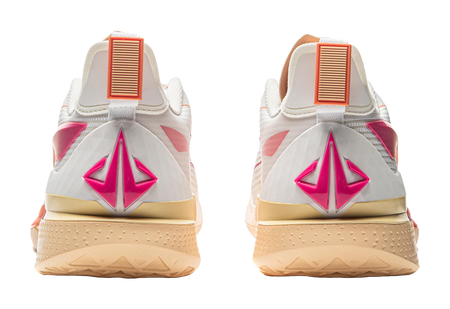 White basketball shoe heels with large magenta logo and orange ribbed tabs