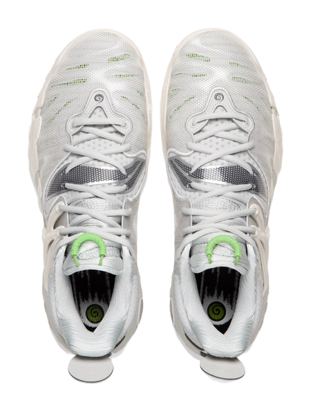 Pair of unisex basketball shoes in white with green lace loops and padded collar