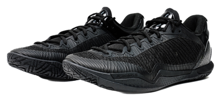 Black low-top basketball shoes, side-by-side view with lace and textured pattern.
