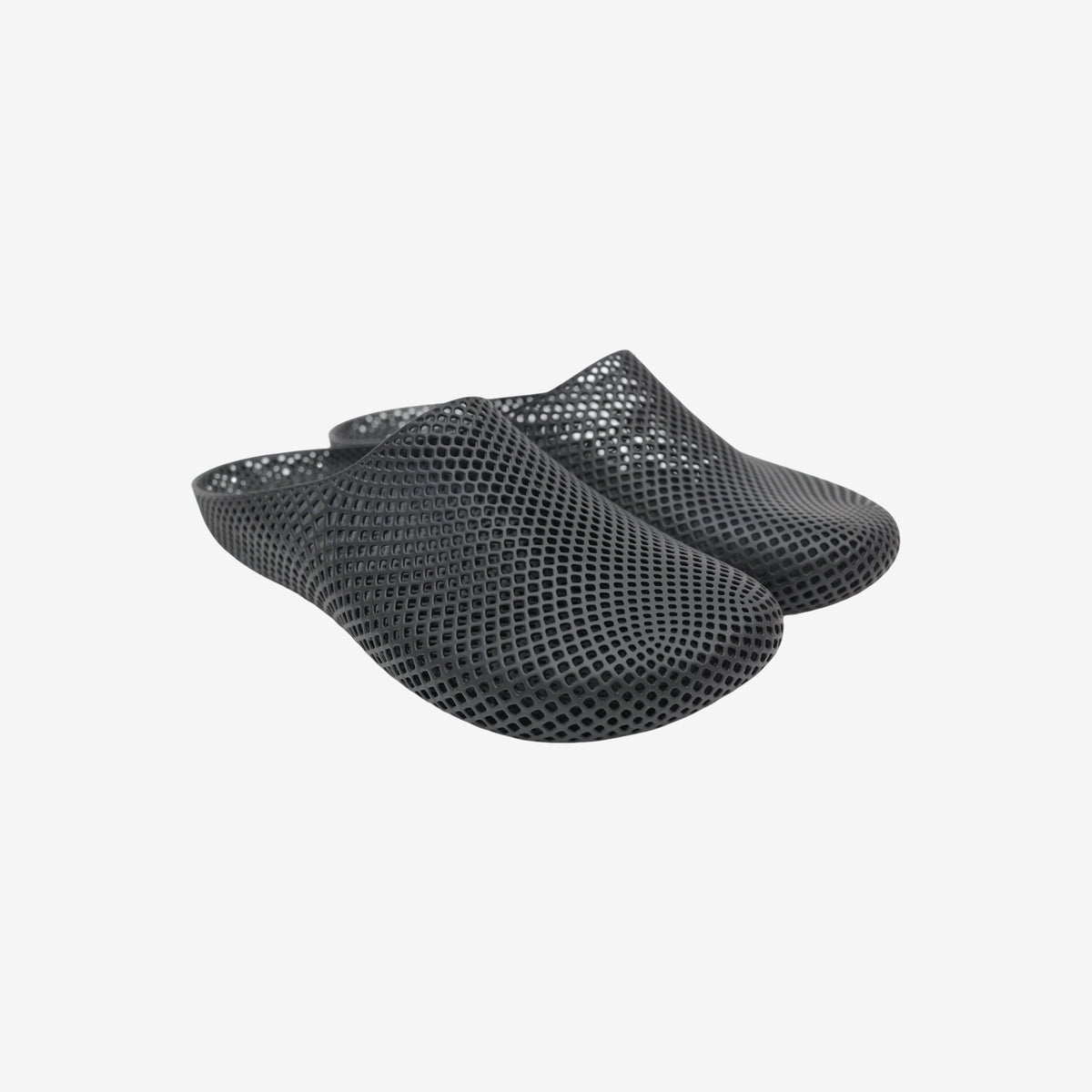 Black 3D printed slippers with open slip-on design and textured mesh surface