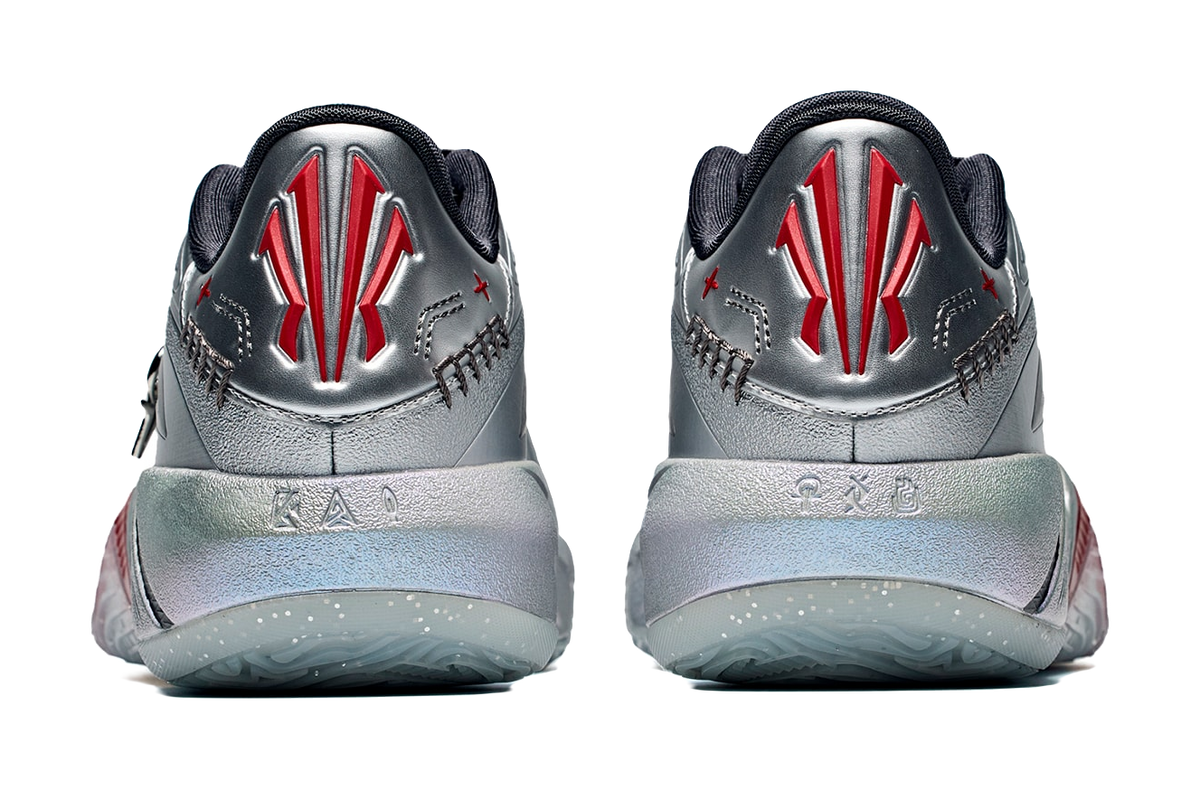 Low basketball shoe heels, silver-gray with black back, red logo and textured sole