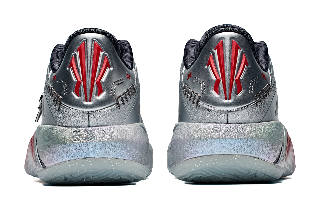 Low basketball shoe heels, silver-gray with black back, red logo and textured sole