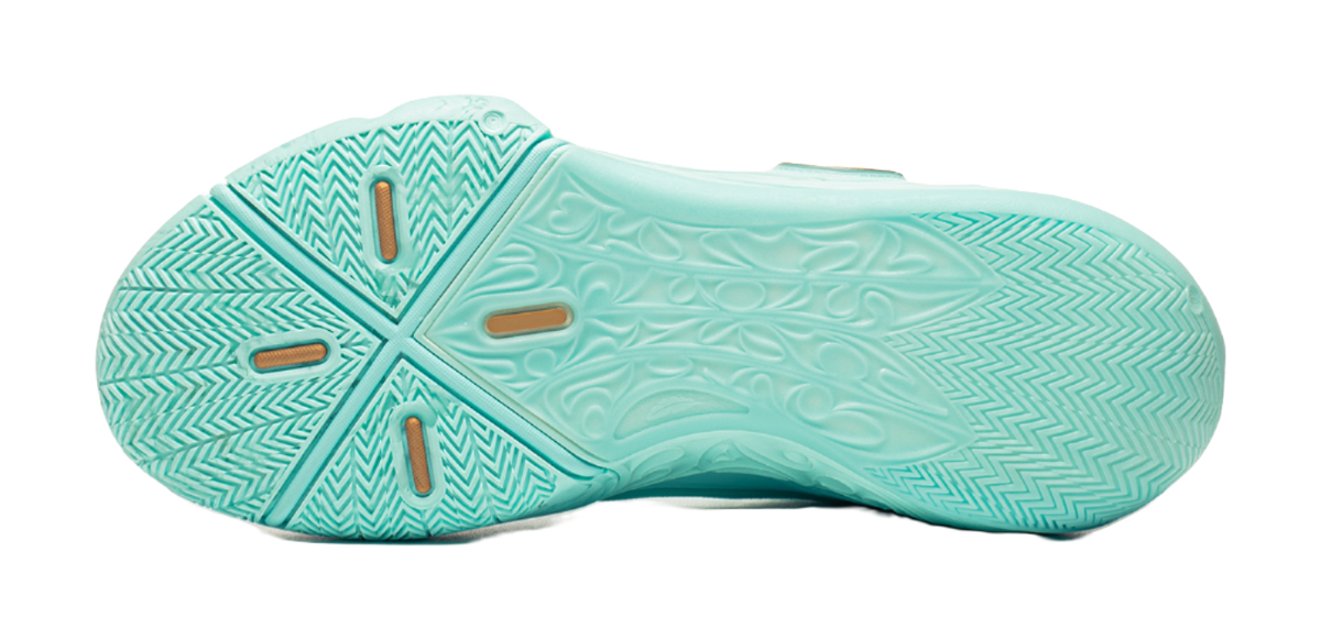 Light teal basketball shoe outsole with textured tread pattern and chevron grooves