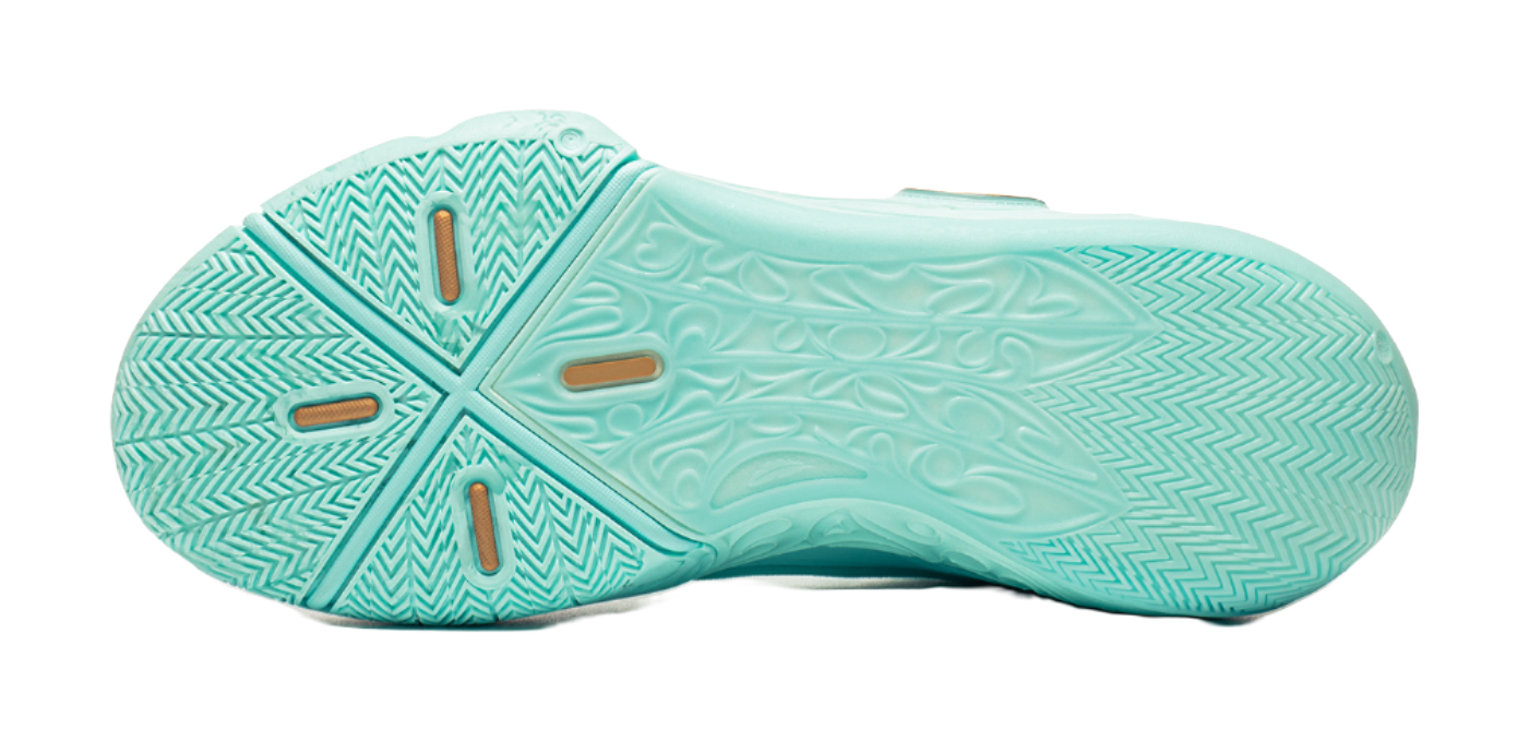 Light teal basketball shoe outsole with textured tread pattern and chevron grooves