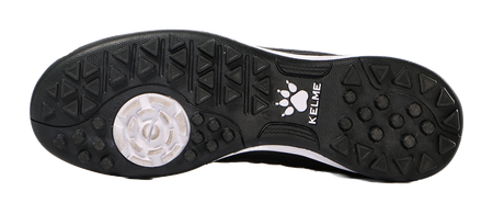Black TF training soccer shoe outsole with molded studs and paw logo