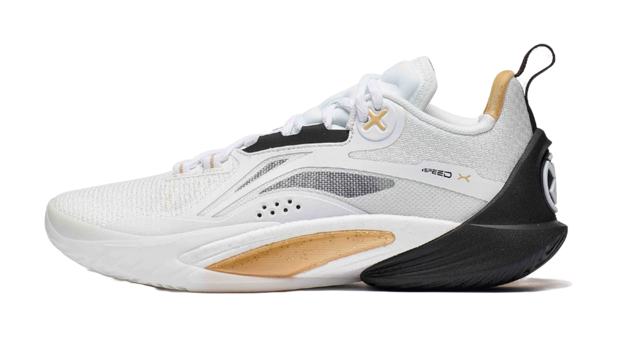 White and black basketball shoe with gold X logo at side, lace-up knit upper