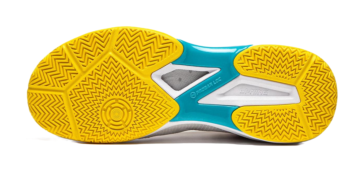 Table tennis shoe outsoles in yellow with zigzag tread and teal center panel