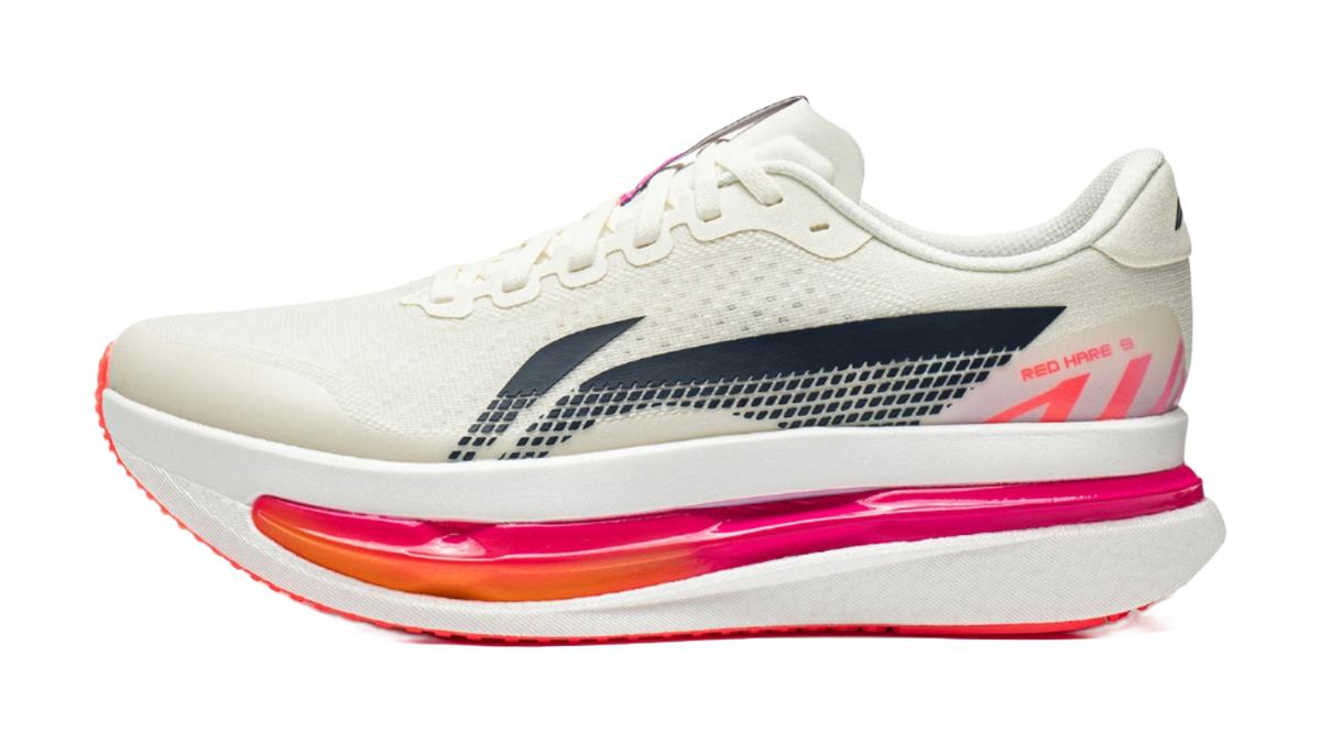 Men's low-top running shoes in white with navy side stripe and pink cushioned sole