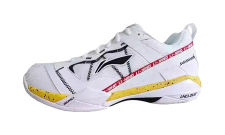 Men's white badminton shoe with black side stripes and yellow outsole accents