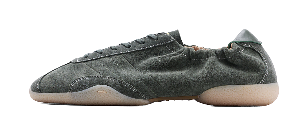Dark green low-top sneakers with lace-up front and rubber sole
