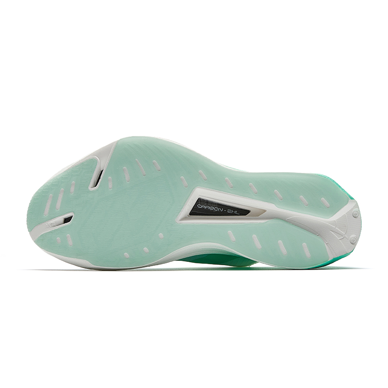 Racing shoe outsole with green tread pattern and black outsole label