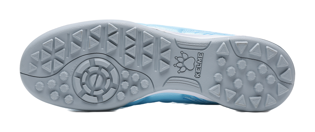 Gray TF turf outsole with stud pattern for blue soccer shoe