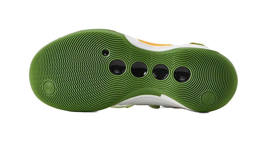 Green rubber outsole of low-top basketball shoes with circular traction pattern.