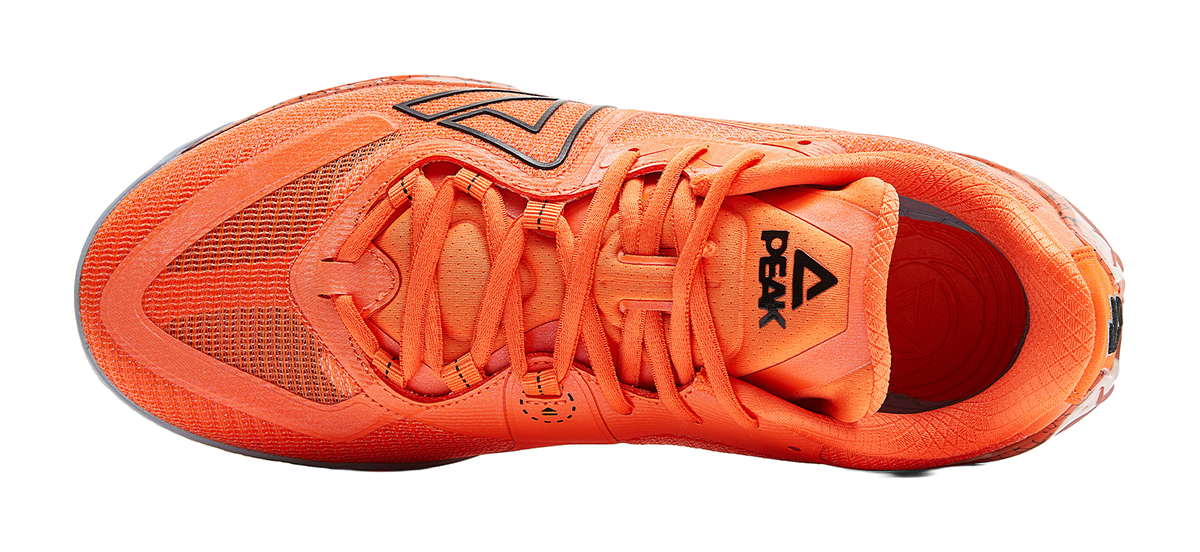 Orange basketball shoe, top view of tongue and laces, black side logo