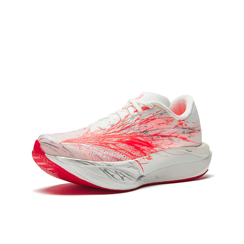 Women's running shoe, white upper with red speckle graphic, lace-up, cushioned sole.