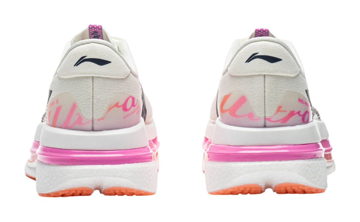 Women's low-top running shoes, rear view with pink midsole and orange outsole trim