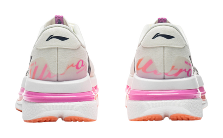 Women's low-top running shoes, rear view with pink midsole and orange outsole trim