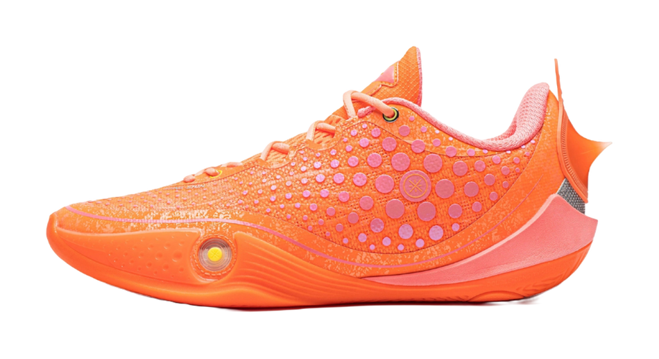 Orange low basketball shoe with textured dots on knit upper and lace-up front