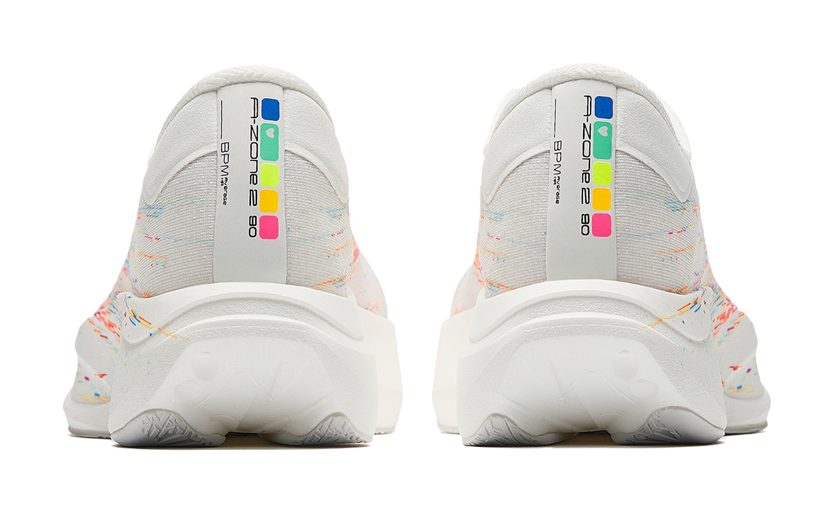 Pair of white running shoes with multicolor heel panel and textured outsole