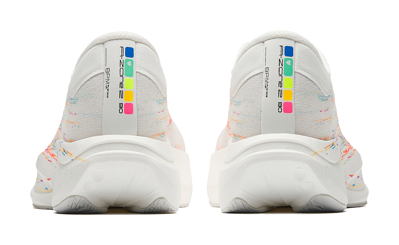 Pair of white running shoes with multicolor heel panel and textured outsole