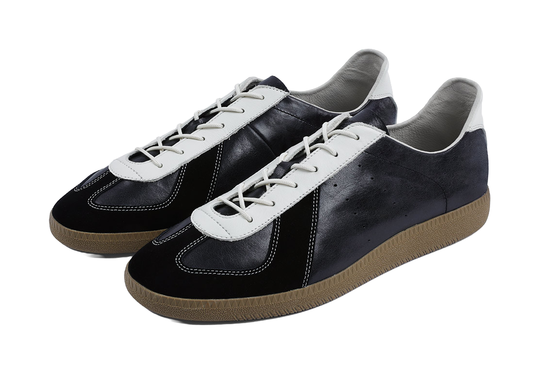 Pair of dark low-top training shoes with white laces and gum rubber soles