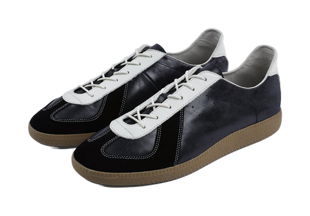 Pair of dark low-top training shoes with white laces and gum rubber soles