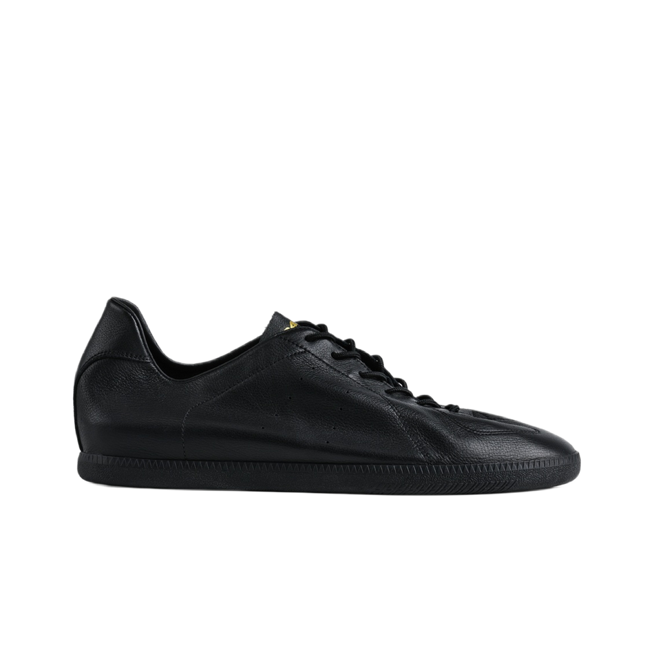 Black low-top lace-up training sneaker with smooth leather upper and rubber sole.