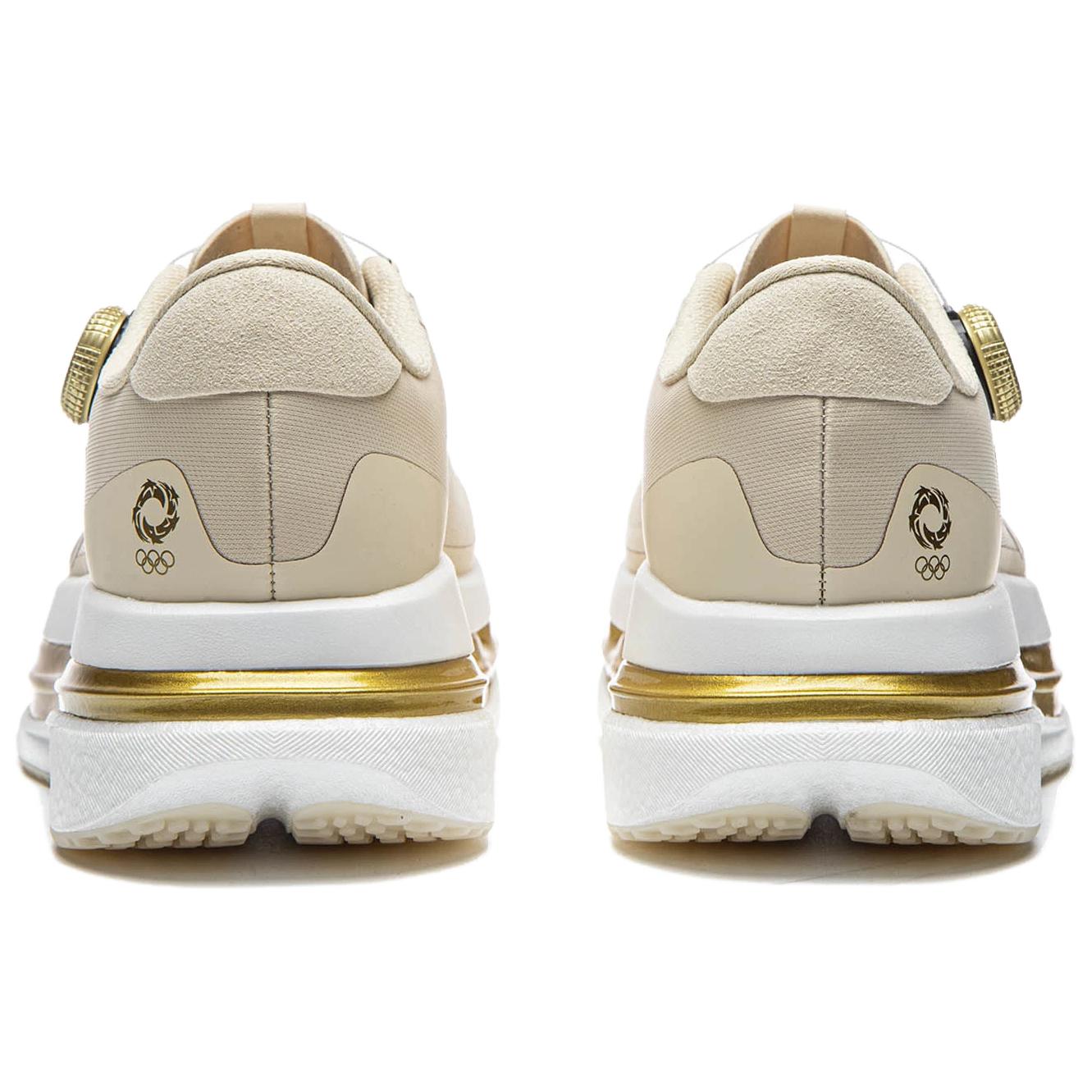 Pair of khaki running shoes showing heel, gold-trimmed midsole, and rear logos