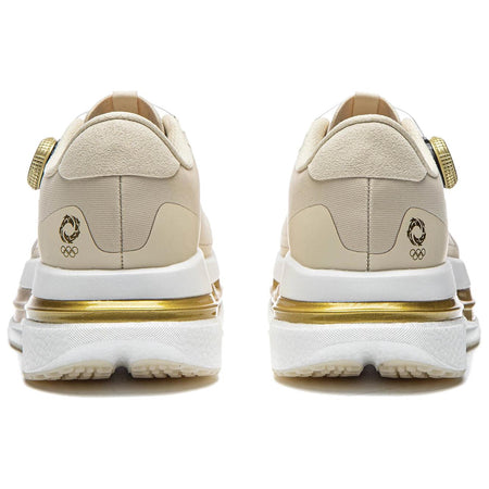 Pair of khaki running shoes showing heel, gold-trimmed midsole, and rear logos
