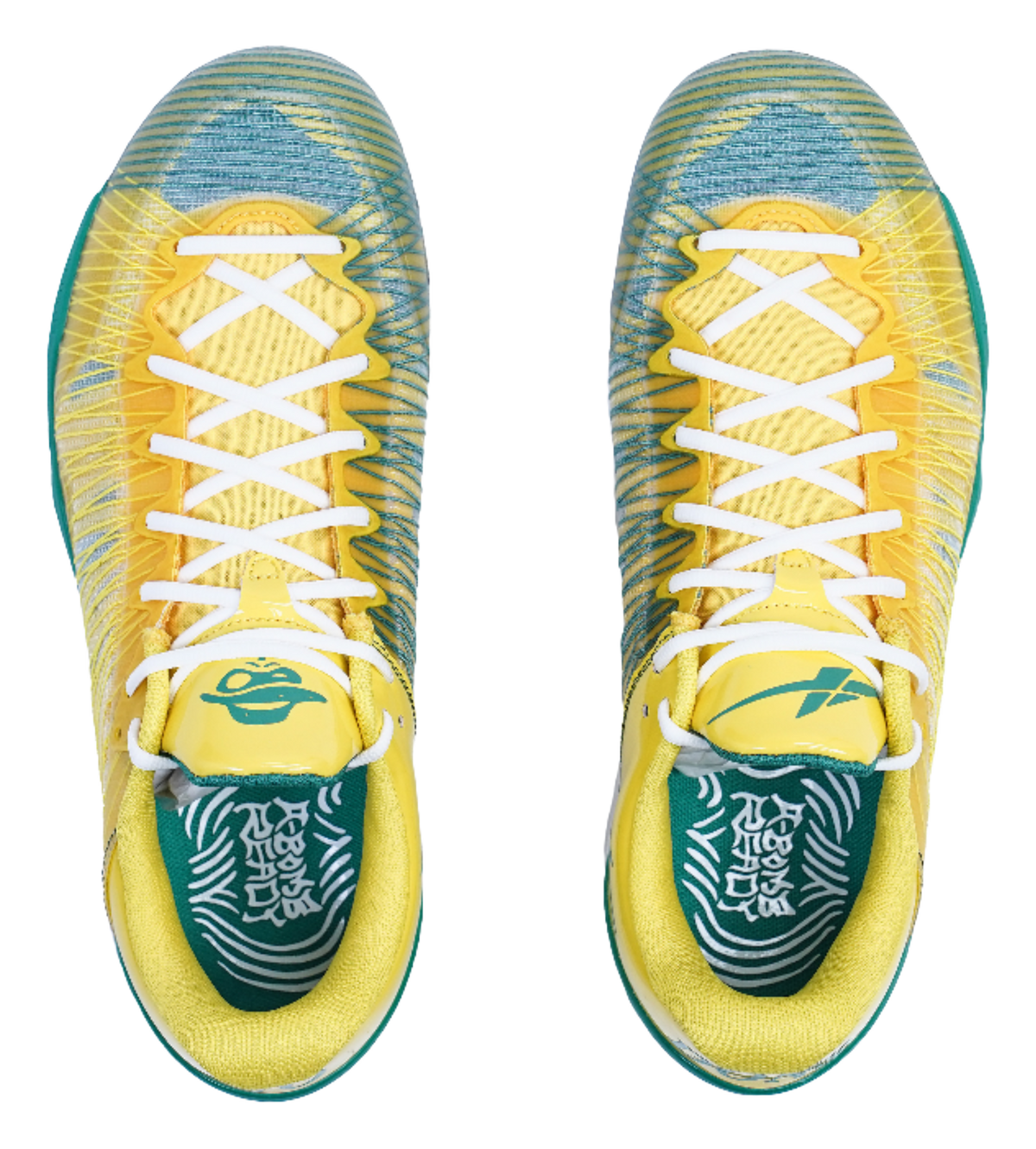 Front view of yellow sneakers with white crisscross laces and green patterned lining