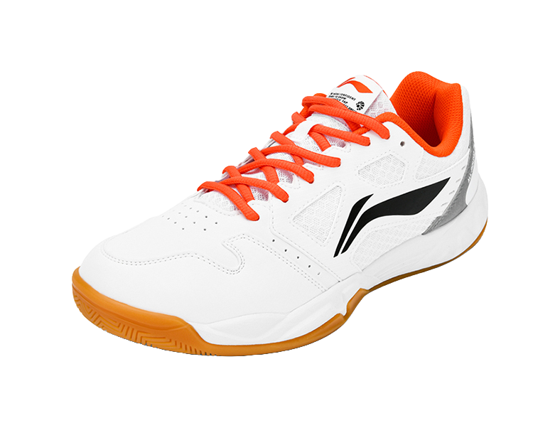White badminton shoe with orange laces, black side logo, and textured upper