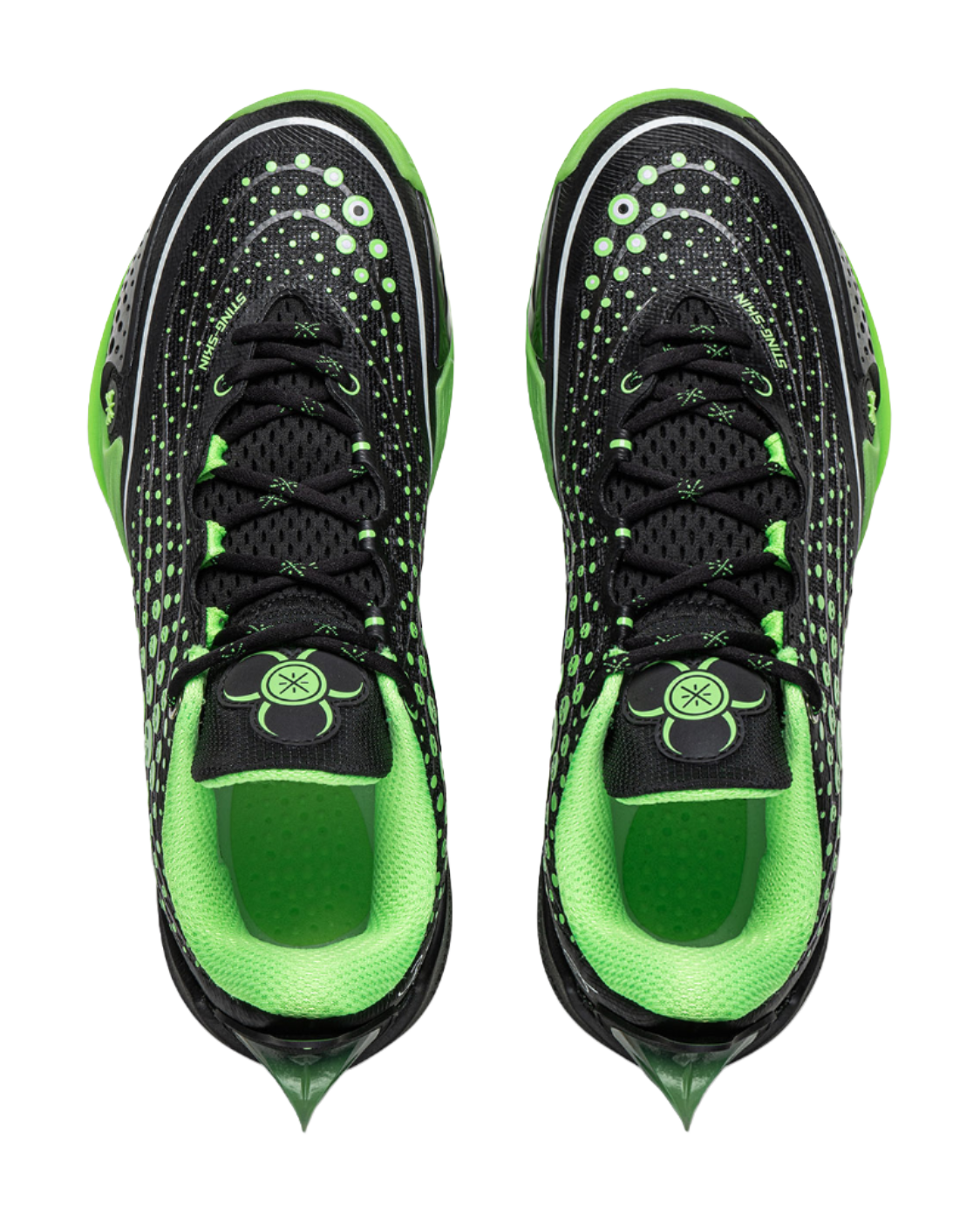 Pair of black and neon green low basketball shoes with lace-up front and graphic details