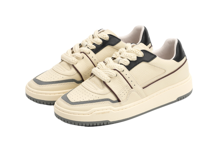 Pair of ecru low-top skate shoes with black details and white lace-up design