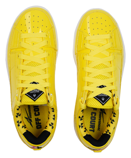 Yellow lace-up basketball shoes showing perforated toe and crosshatch laces