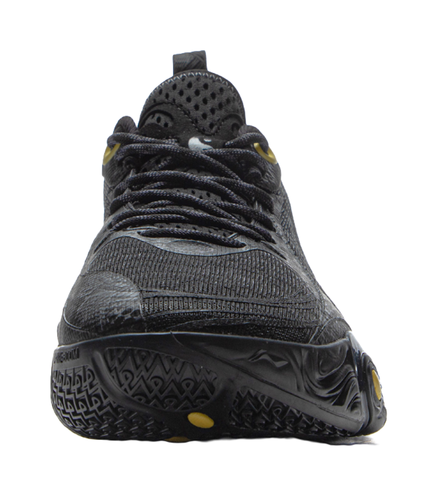 Black basketball shoe with laces, perforated toe, and gold vertical accents