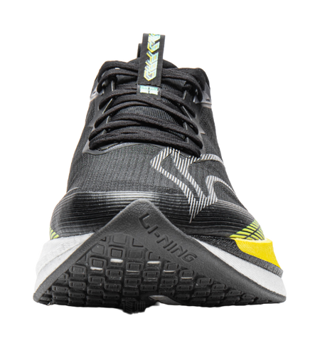 Unisex running shoe close-up, black mesh upper with yellow heel stripe and lace detail